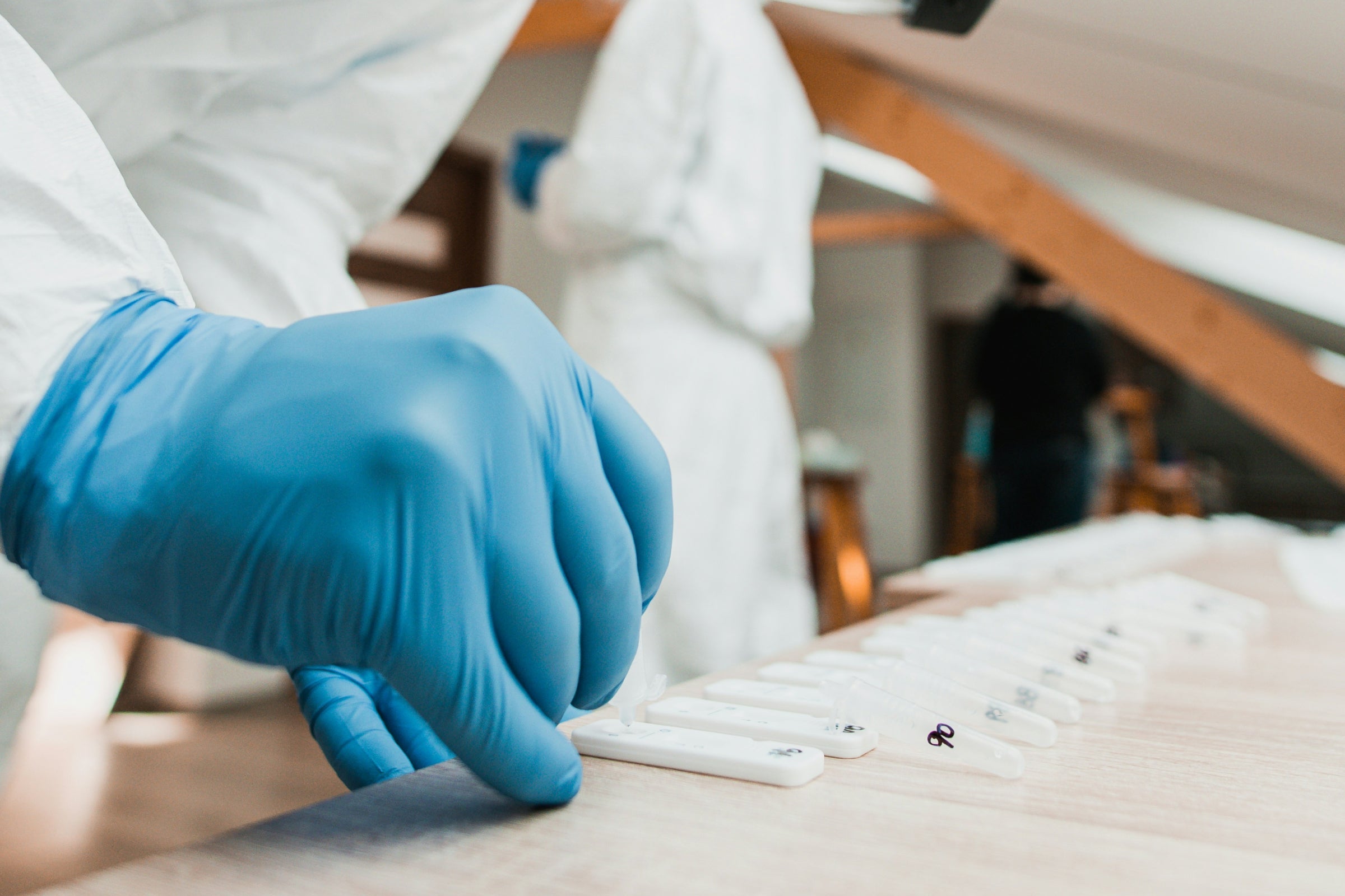 Researcher conducting COVID-19 clinical trial representing NAD+ and nicotinamide riboside (NR) findings.