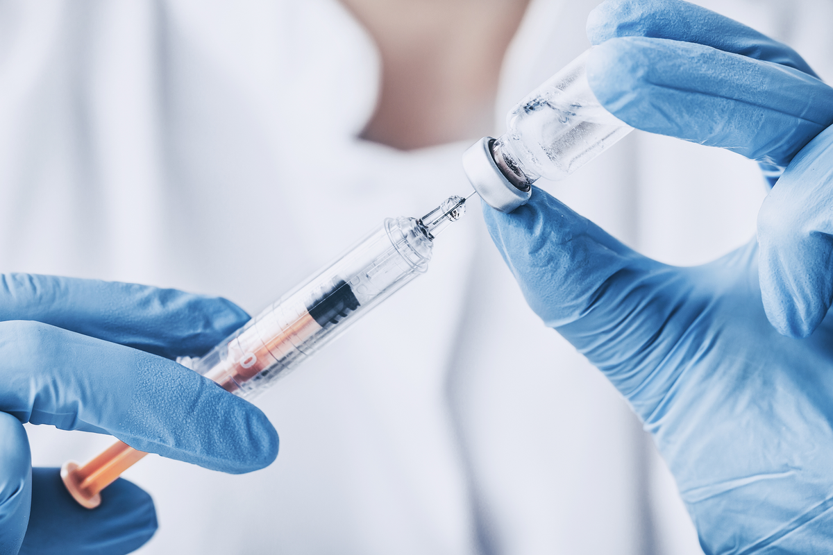 Syringe and vial representing human research on subcutaneous and intramuscular NAD+ injections.