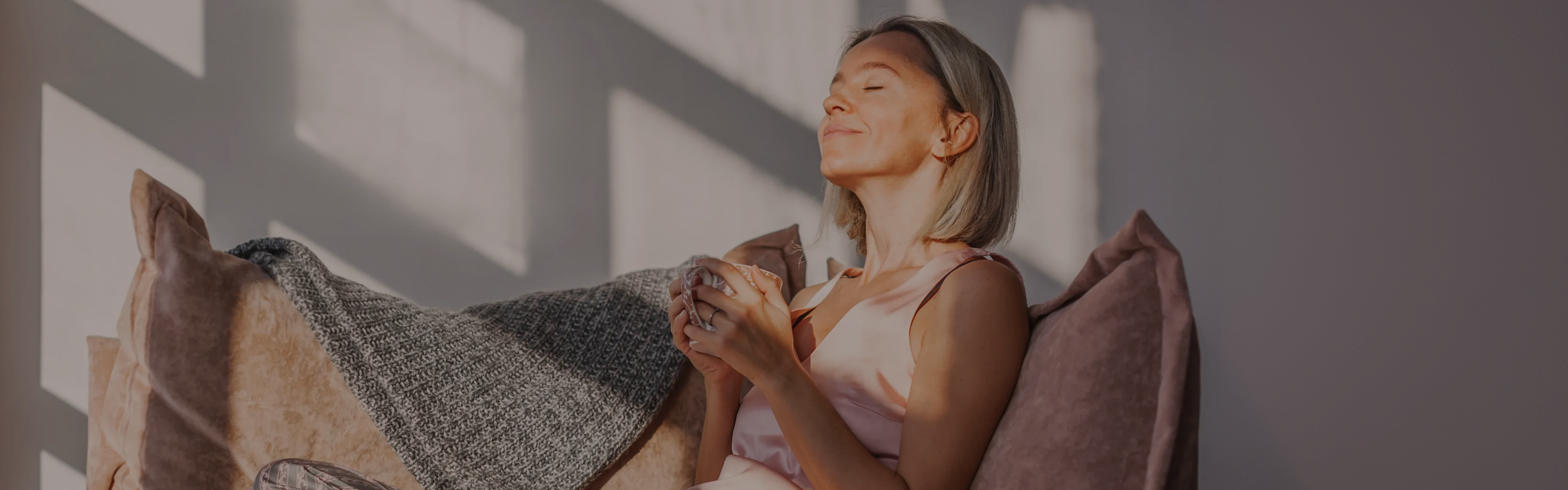 Woman drinking coffee, illustrating the connection between metabolic health, NAD+, and GLP-1s.