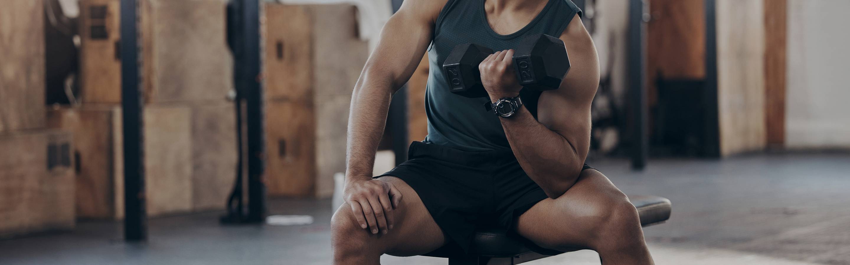 Individual holding a dumbbell while exercising, illustrating the connection between NAD+, muscle strength, recovery, and healthy aging.