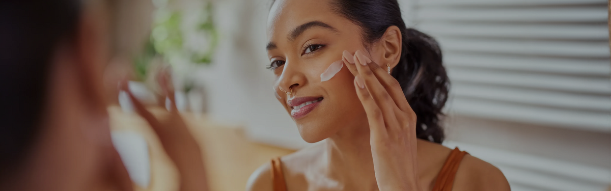 Woman applying topical skincare representing NAD+, NR, and skin health research.