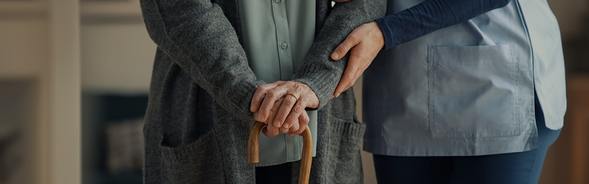 Older adult with aging hands gripping a walking cane, illustrating the link between low NAD+ levels and age-related frailty.