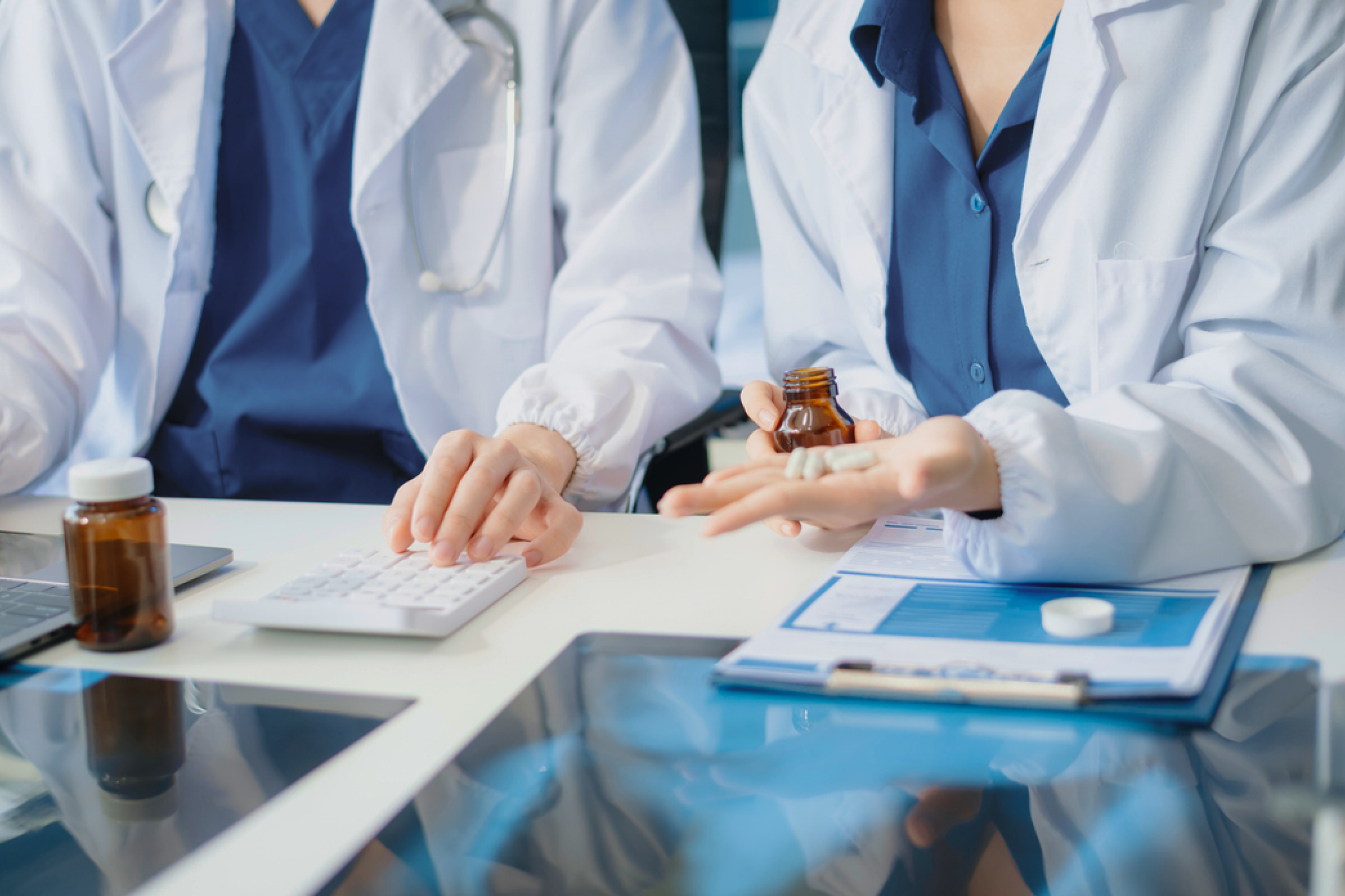 Scientists in lab coats reviewing capsules representing NAD+ and long COVID research.